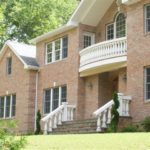 brick house with baluster railing